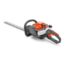 Husqvarna 122HD60 petrol hedgecutter with orange and gray body, 60 cm dual-action blade, and ergonomic handle for efficient hedge and shrub trimming.