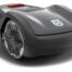 Husqvarna Automower Aspire R4 robotic lawn mower navigating a large, sloped garden with trees and shrubs.