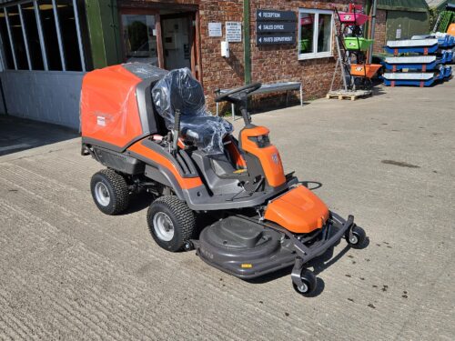 Husqvarna RC 318T Rider lawn mower with 112cm front-mounted cutting deck in action on a large garden lawn