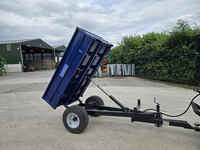 Oxdale 1.5T Tipping Trailer with hydraulic tip and wide turf tyres, shown with removable side panels for use as a flatbed, designed for transporting soil, logs, and other loose materials on agricultural land.
